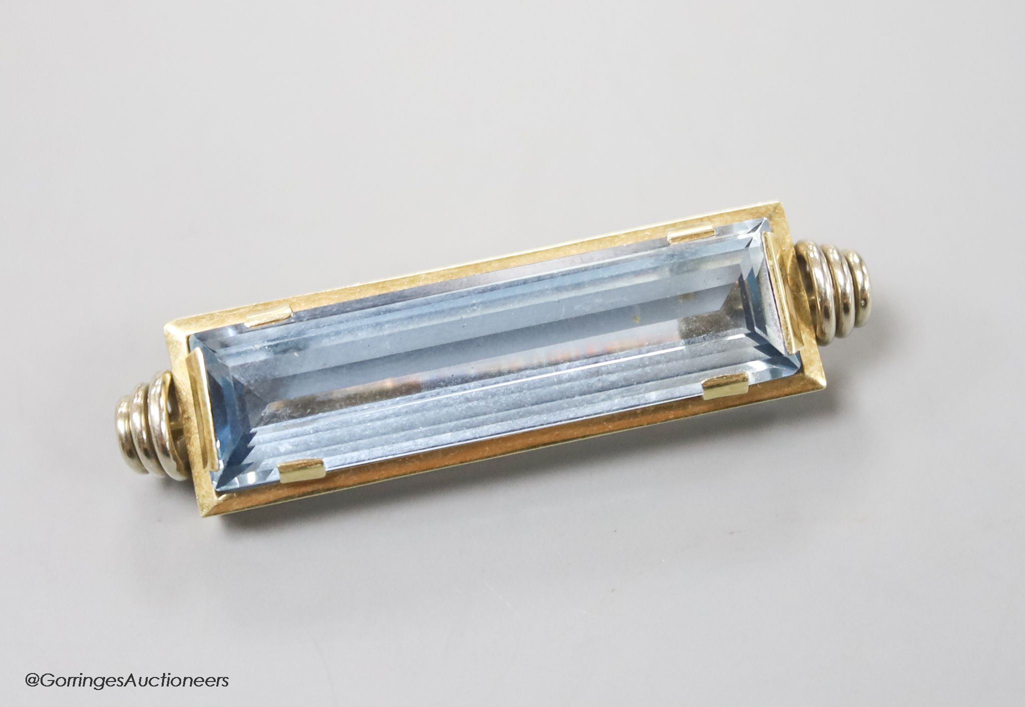 A modern 585yellow metal and blue paste set rectangular brooch, 47mm, gross 13 grams.
